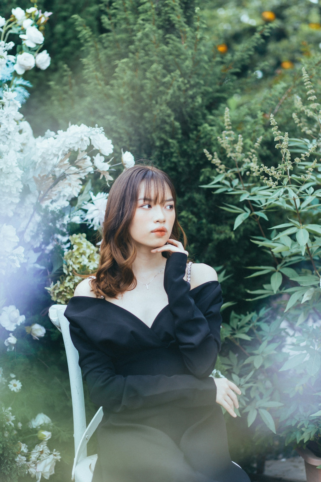 a woman sitting in a garden