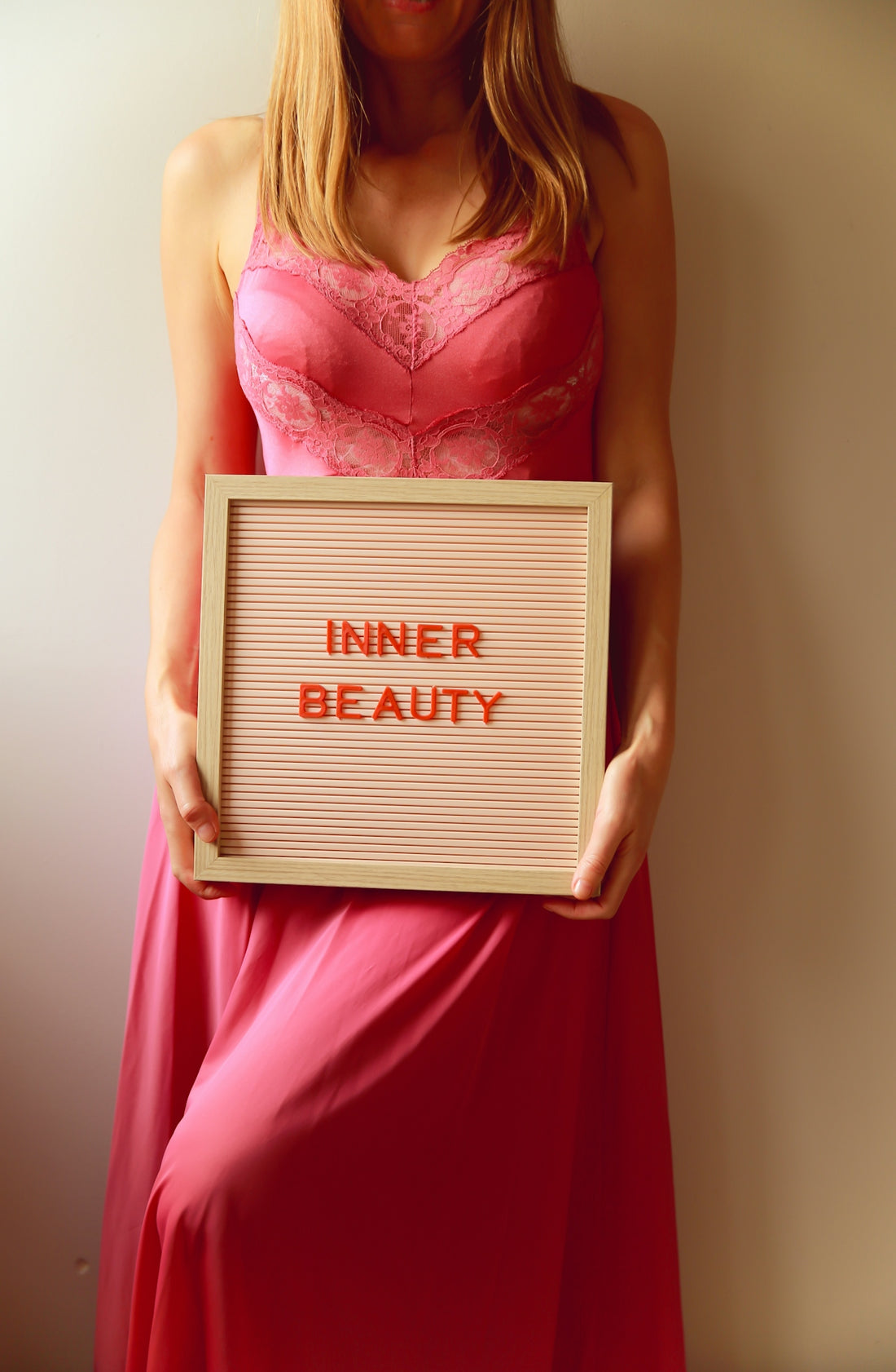 Woman holds sign reading inner beauty.